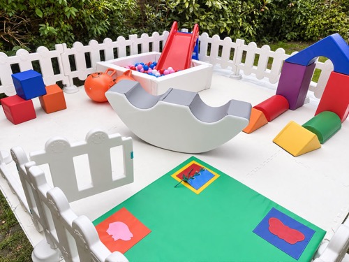Soft play blocks, arch and sensory mat in a garden mini park set-up