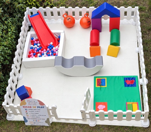 Ball pit, slide and soft play blocks in a garden mini park set-up