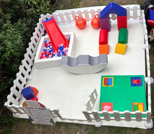 Overhead view of a full mini park set-up with ball pit, slide, blocks and sensory mat