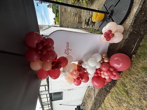 Personalised balloon garland backdrop, styled with an independent partner