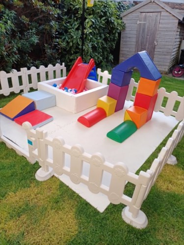 Fenced mini soft play park with slide, ball pit and foam blocks